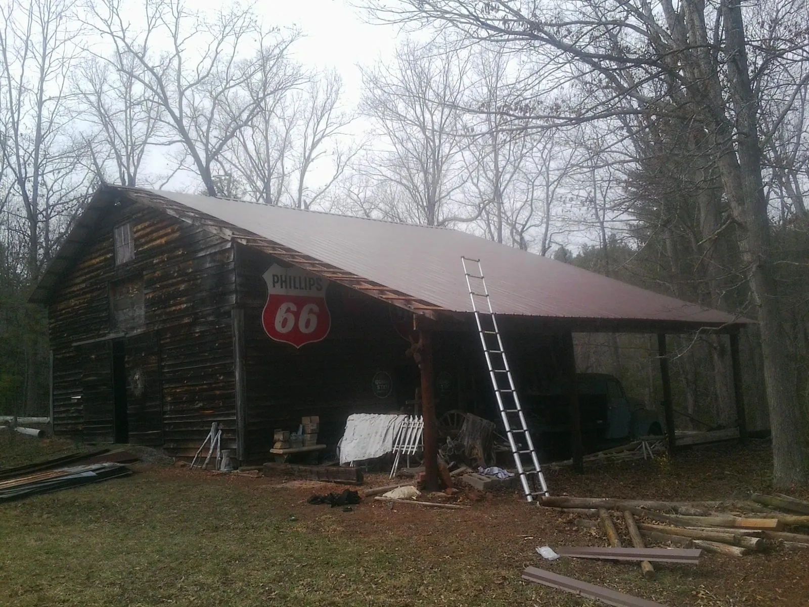 New metal roof on an open sided timber barn with a vintage sign in Clarinda